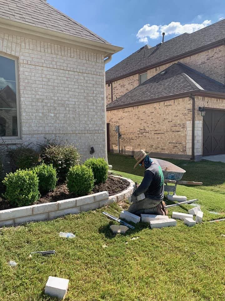 The Jr Stone Work crew building a stone border on a job