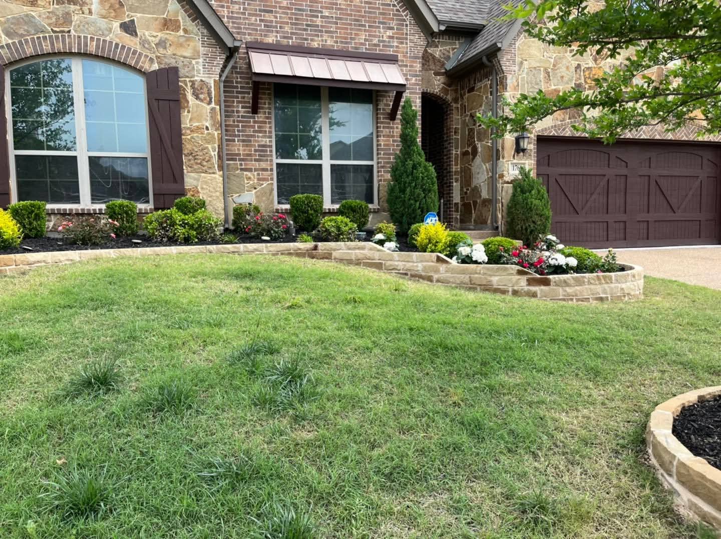 Flower beds edged with flagstone