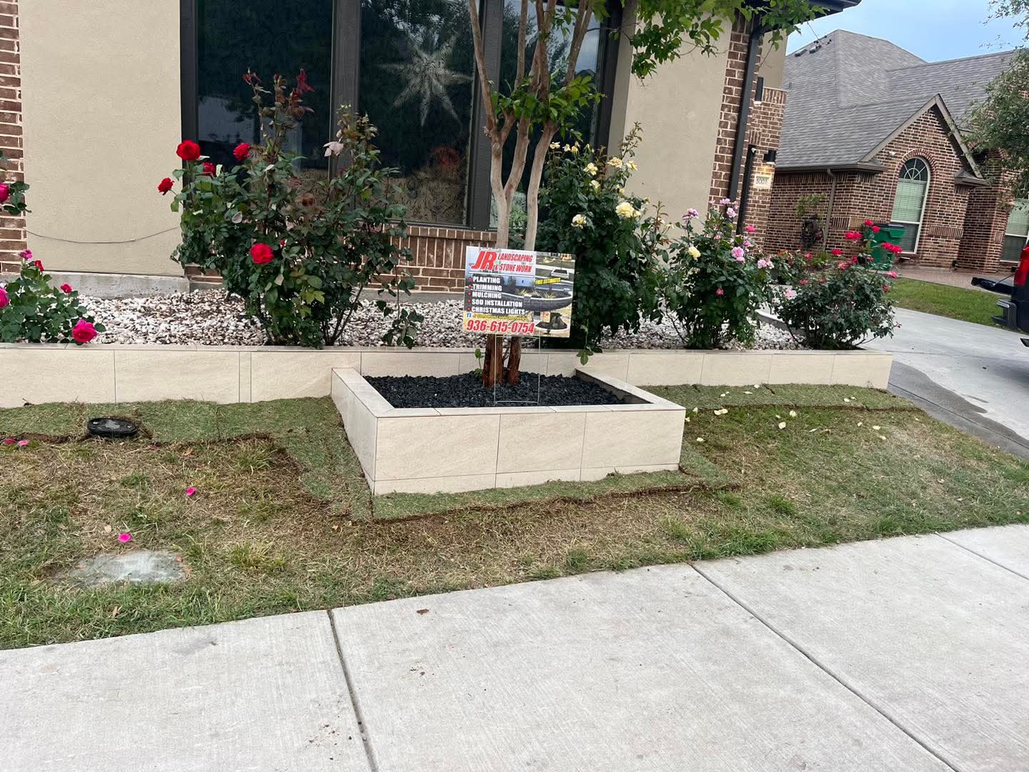 A tiled stone planter filled with roses