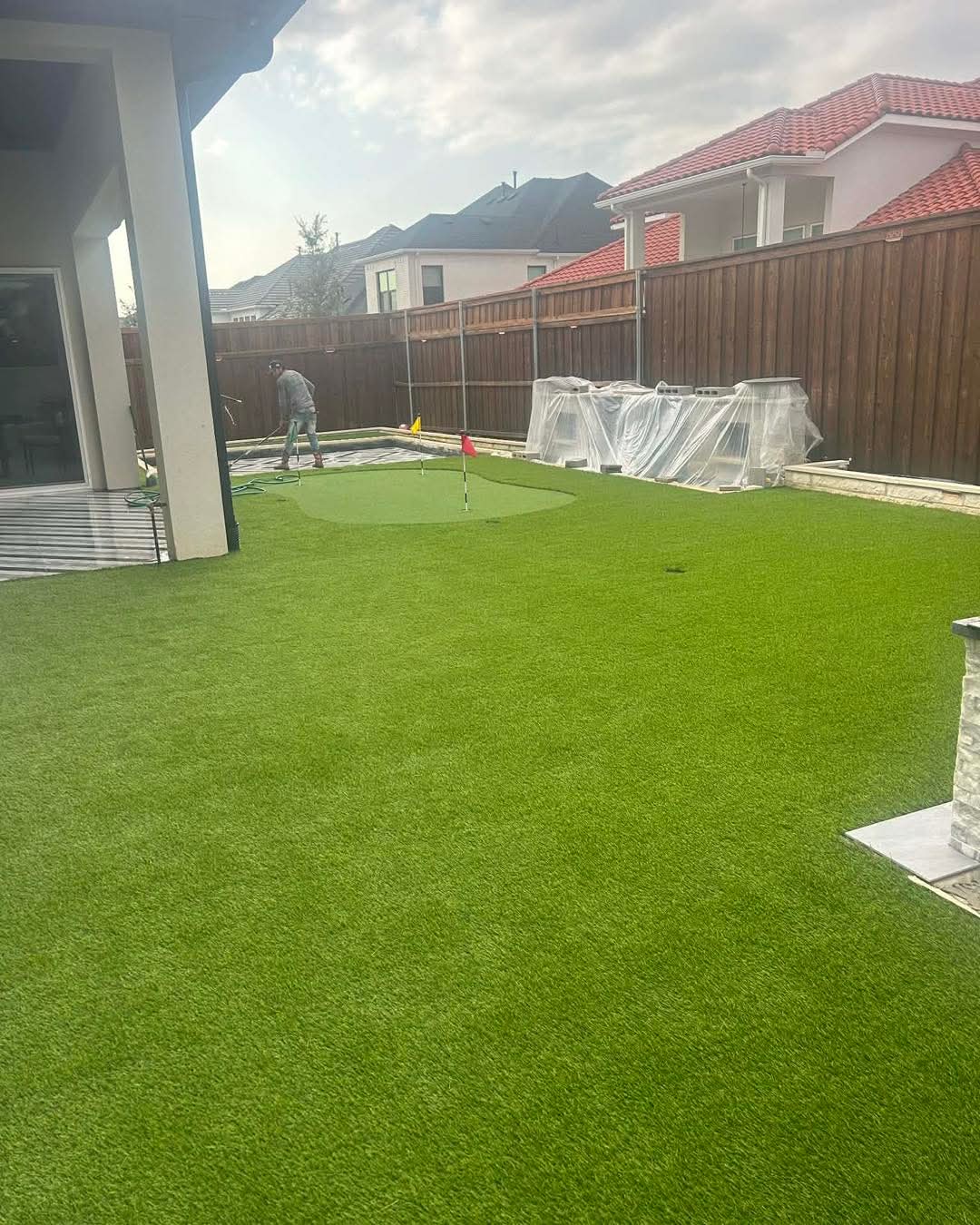 A full turf yard with a putting green