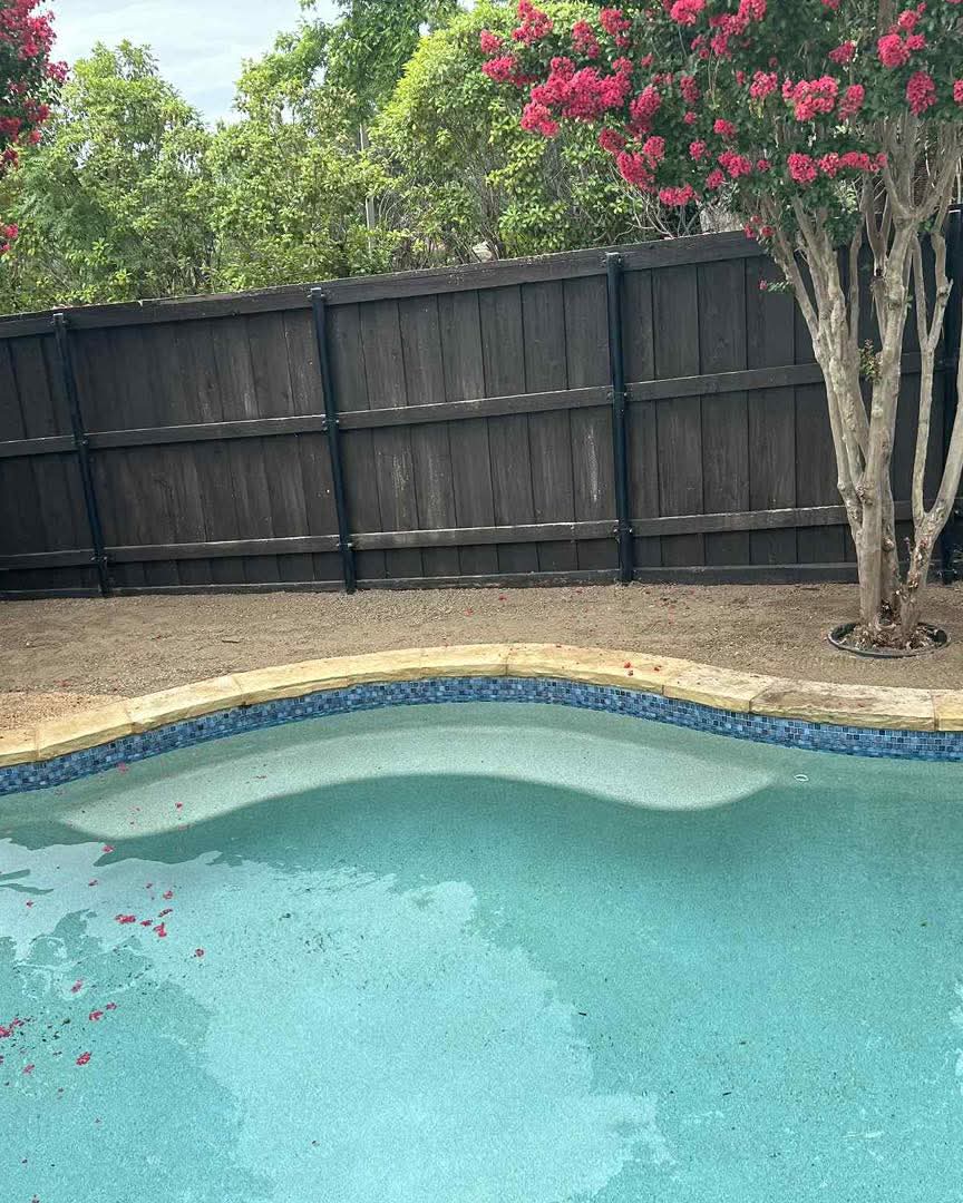 Artificial turf beside a stacked stone wall